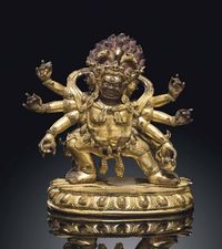 17TH CENTURY A GILT-BRONZE FIGURE OF MAHAKALA