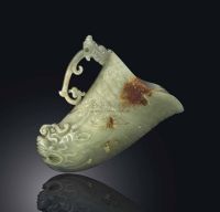 LATE MING/EARLY QING DYNASTY，17TH CENTURY A PALE CELADON AND RUSSET JADE RHYTON
