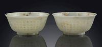 18TH CENTURY A PAIR OF INSCRIBED AND GILT-DECORATED PALE CELADON JADE BOWLS