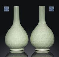 A PAIR OF CELADON-GLAZED MOULDED BOTTLE VASES